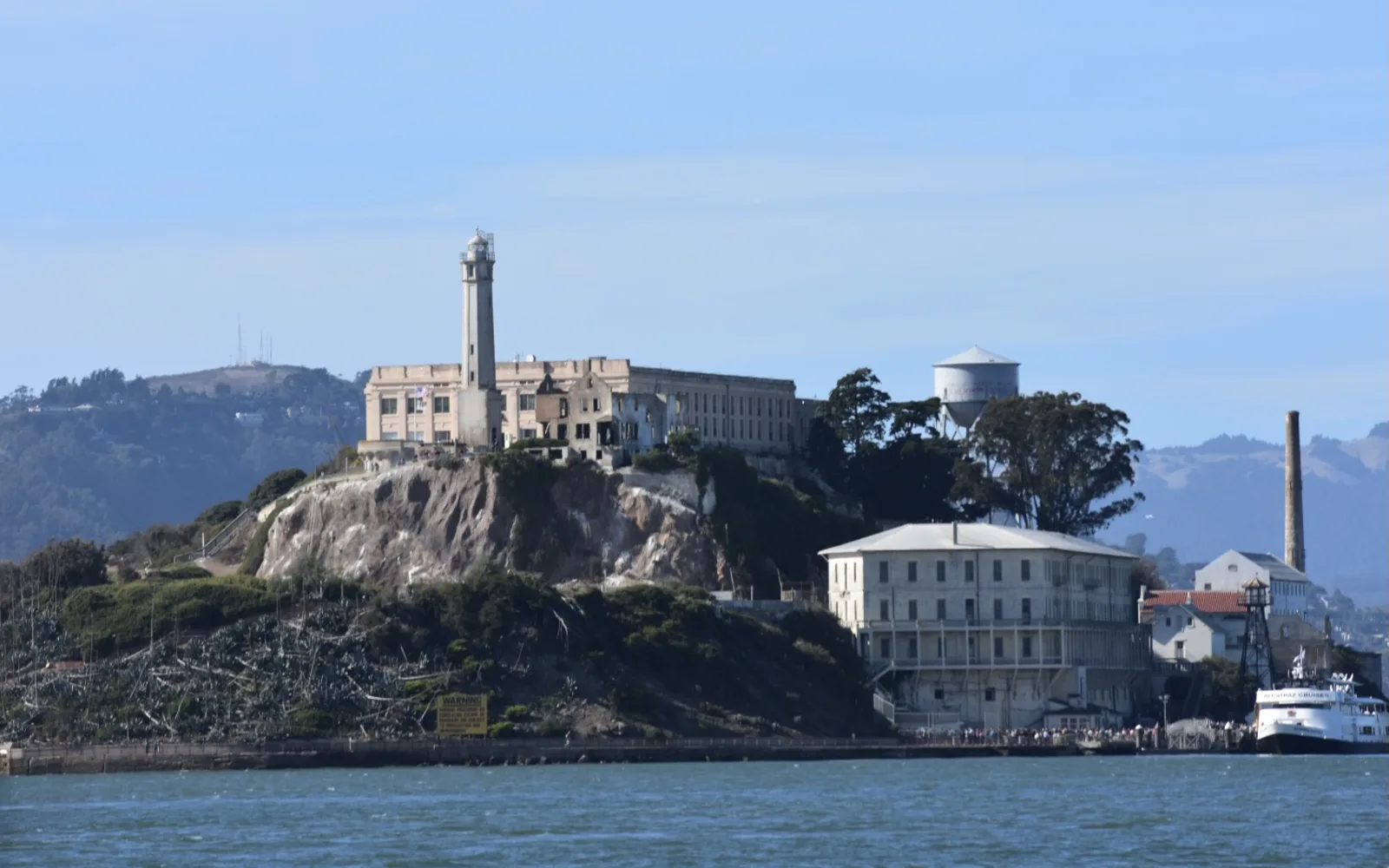 Alcatraz Island viewed from San Francisco Bay, showing the historic prison buildings and structures on the island.
