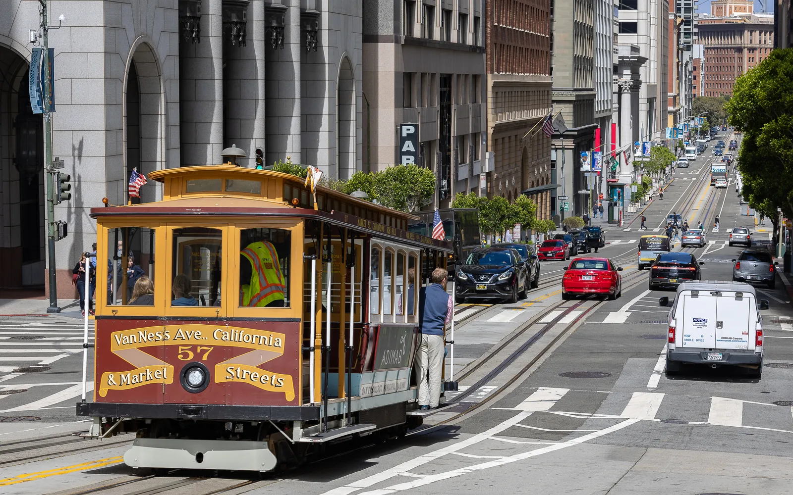 San Francisco Cable Car No. 57 operating on California Street, showing the iconic yellow cable car vehicle on its tracks.